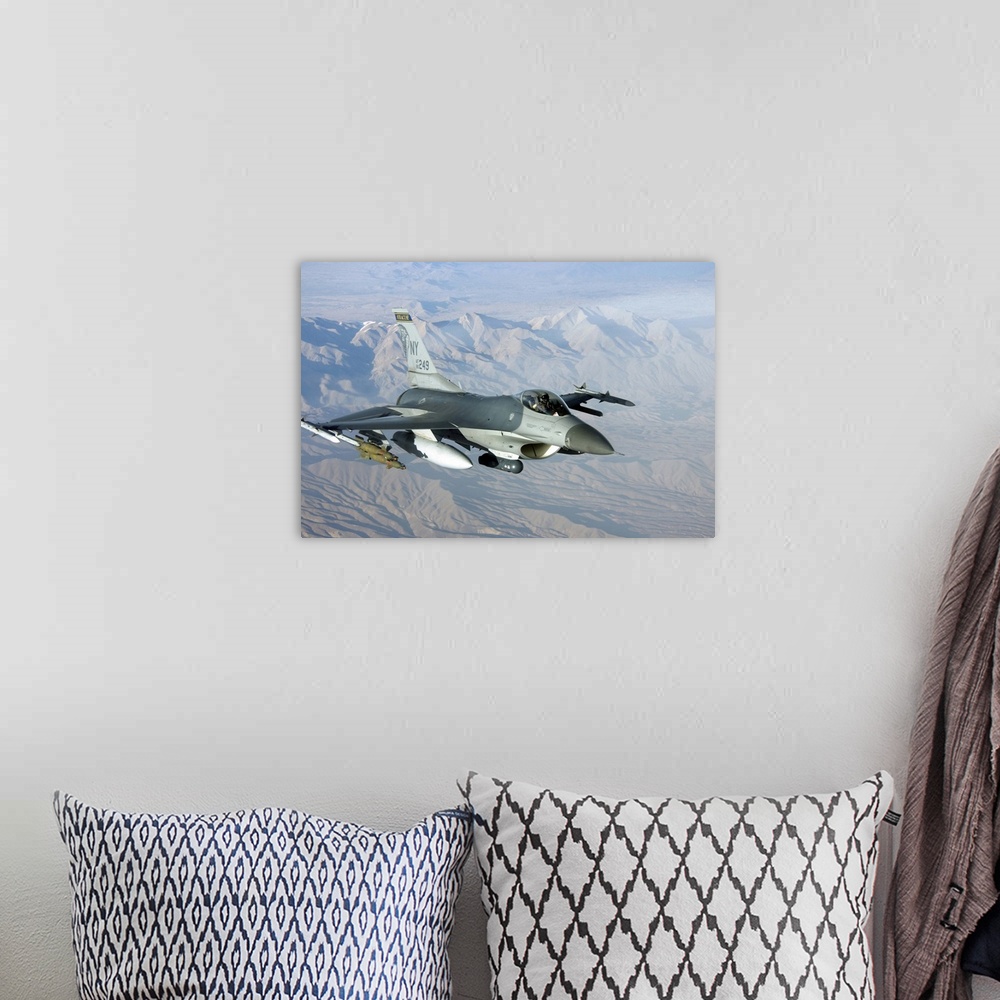 A bohemian room featuring A U.S. Air Force F-16C Fighting Falcon in flight over Afghanistan.