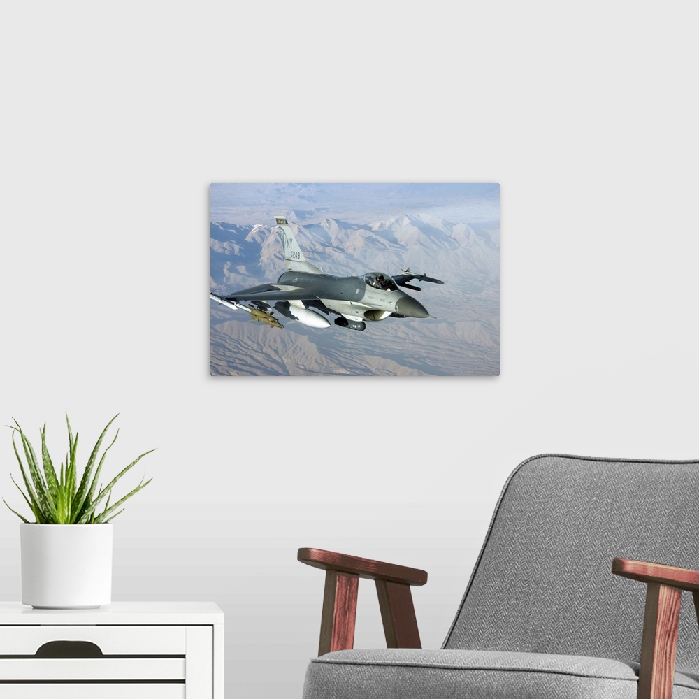 A modern room featuring A U.S. Air Force F-16C Fighting Falcon in flight over Afghanistan.