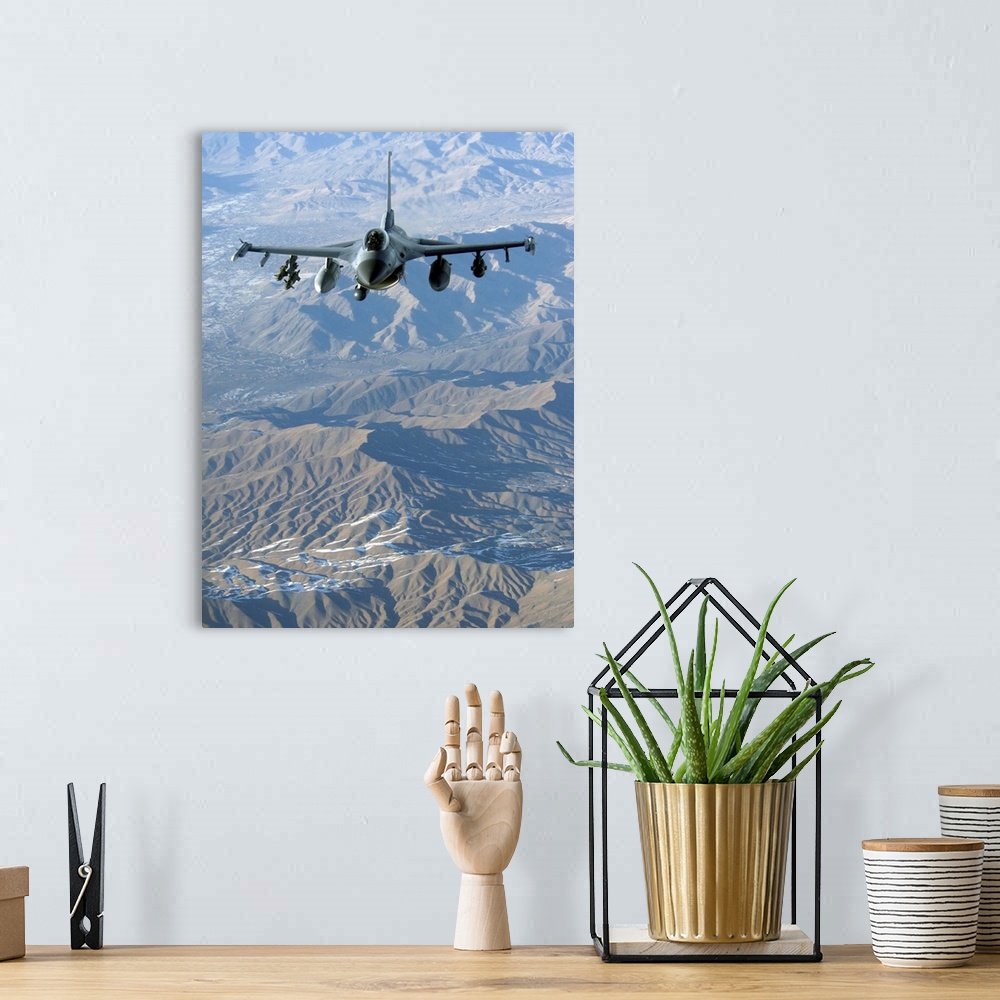 A bohemian room featuring A U.S. Air Force F-16C Fighting Falcon in flight over Afghanistan.