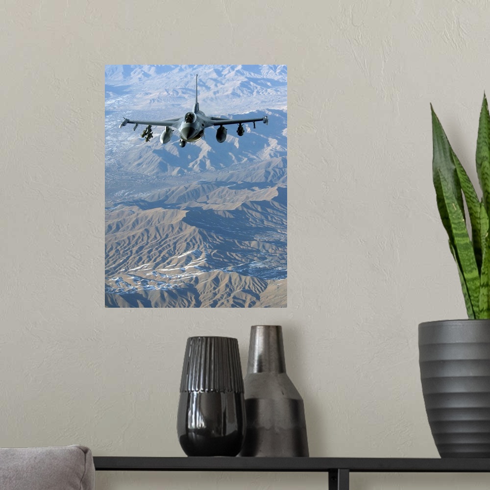 A modern room featuring A U.S. Air Force F-16C Fighting Falcon in flight over Afghanistan.