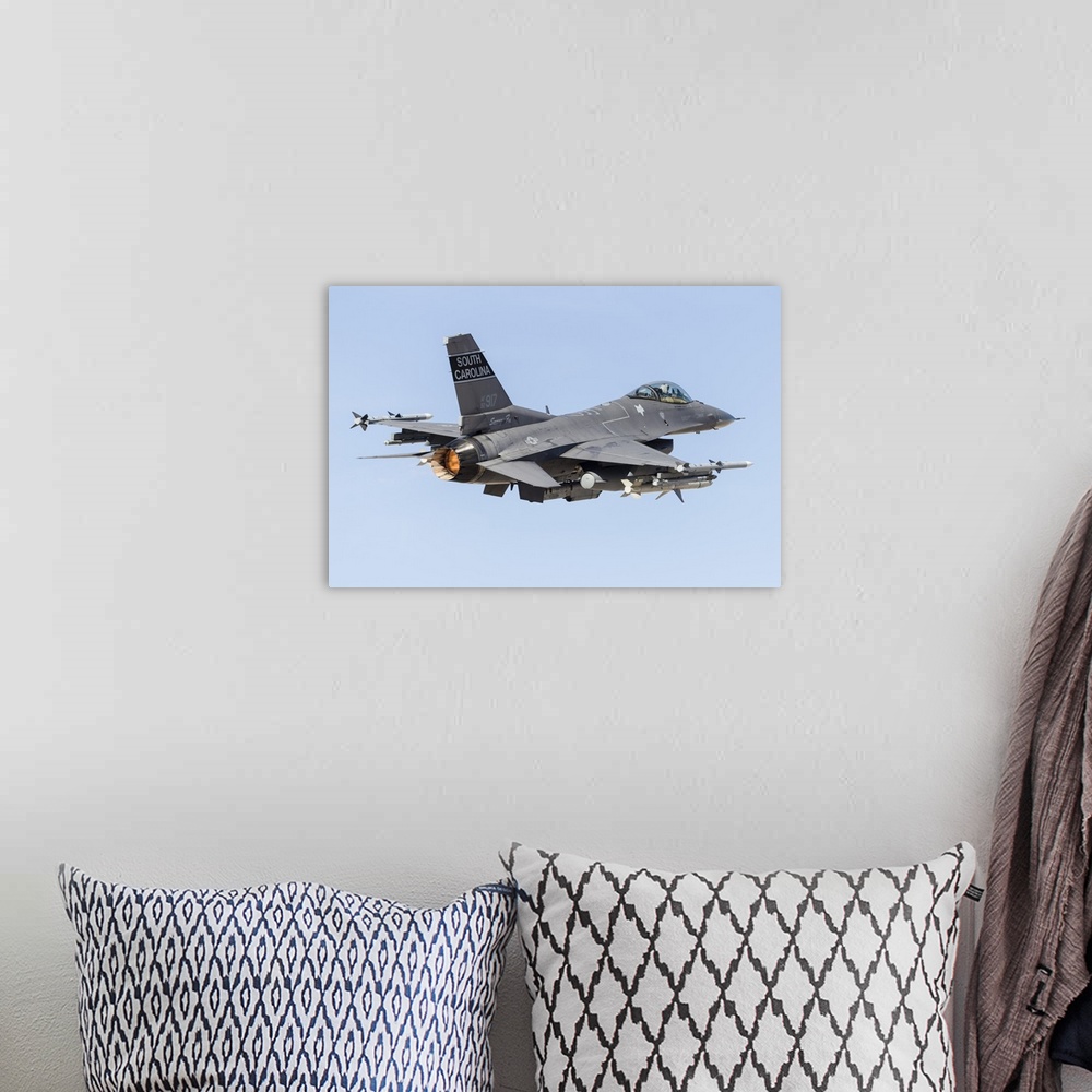 A bohemian room featuring A U.S. Air Force F-16C Fighting Falcon taking off.