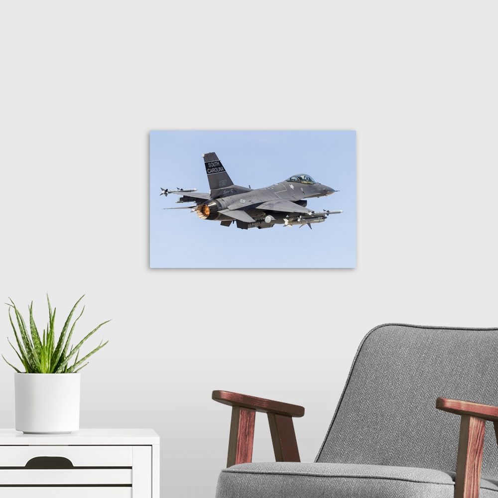 A modern room featuring A U.S. Air Force F-16C Fighting Falcon taking off.