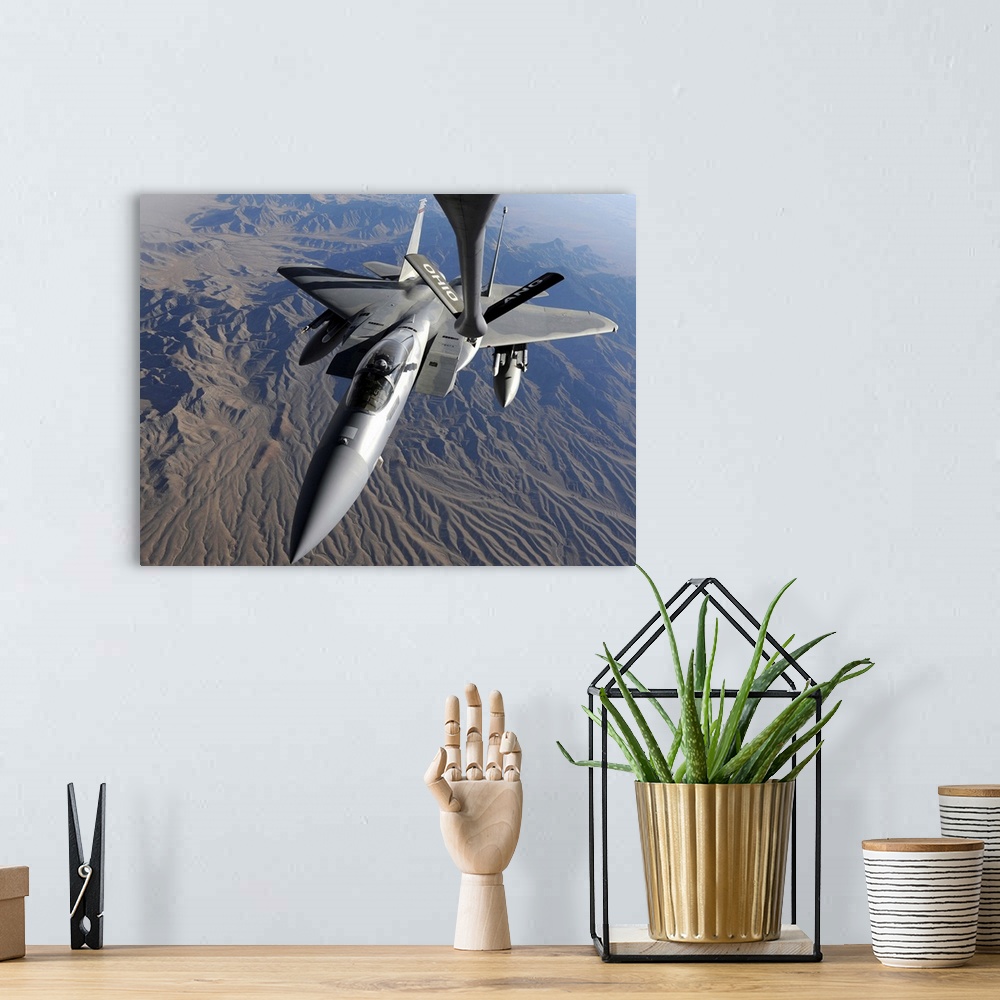 A bohemian room featuring A US Air Force F15 Eagle flies toward the boom of a KC135 Stratotanker