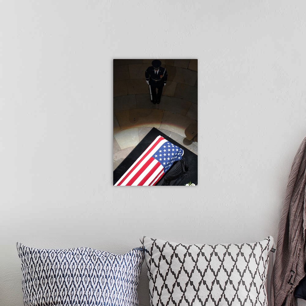 A bohemian room featuring A U.S. Air Force Honor Guardsman stands watch over the casket.