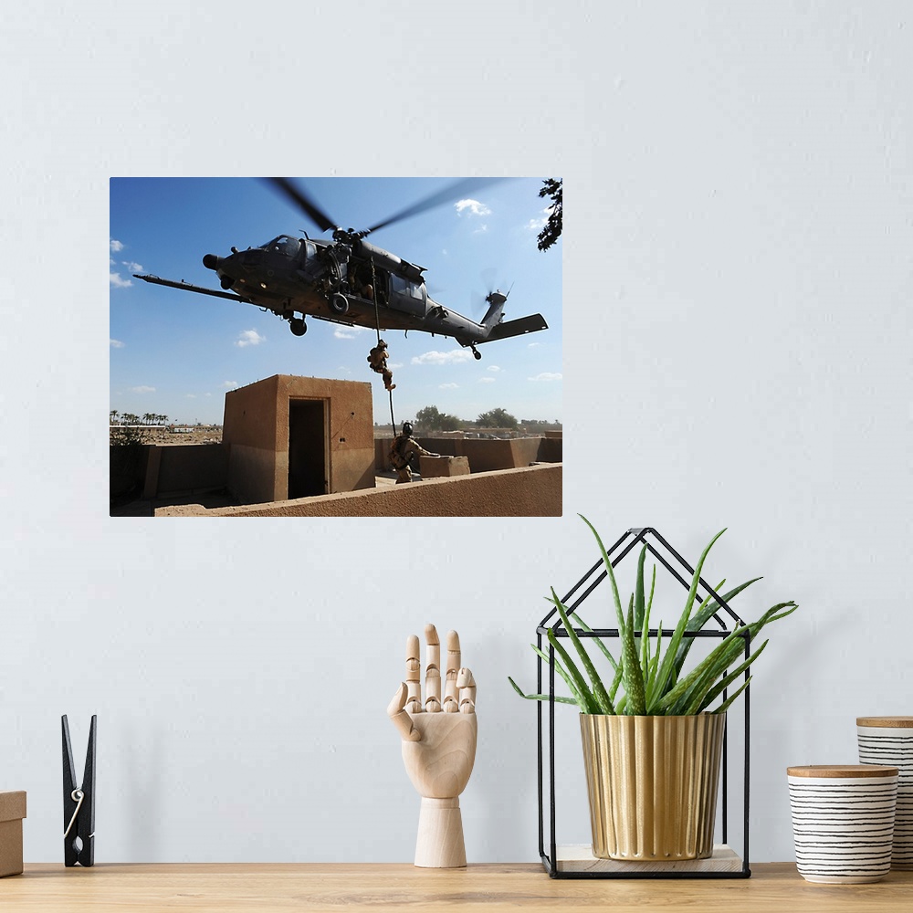 A bohemian room featuring A US Air Force Pararescuemen fast ropes from an HH60 Pavehawk helicopter