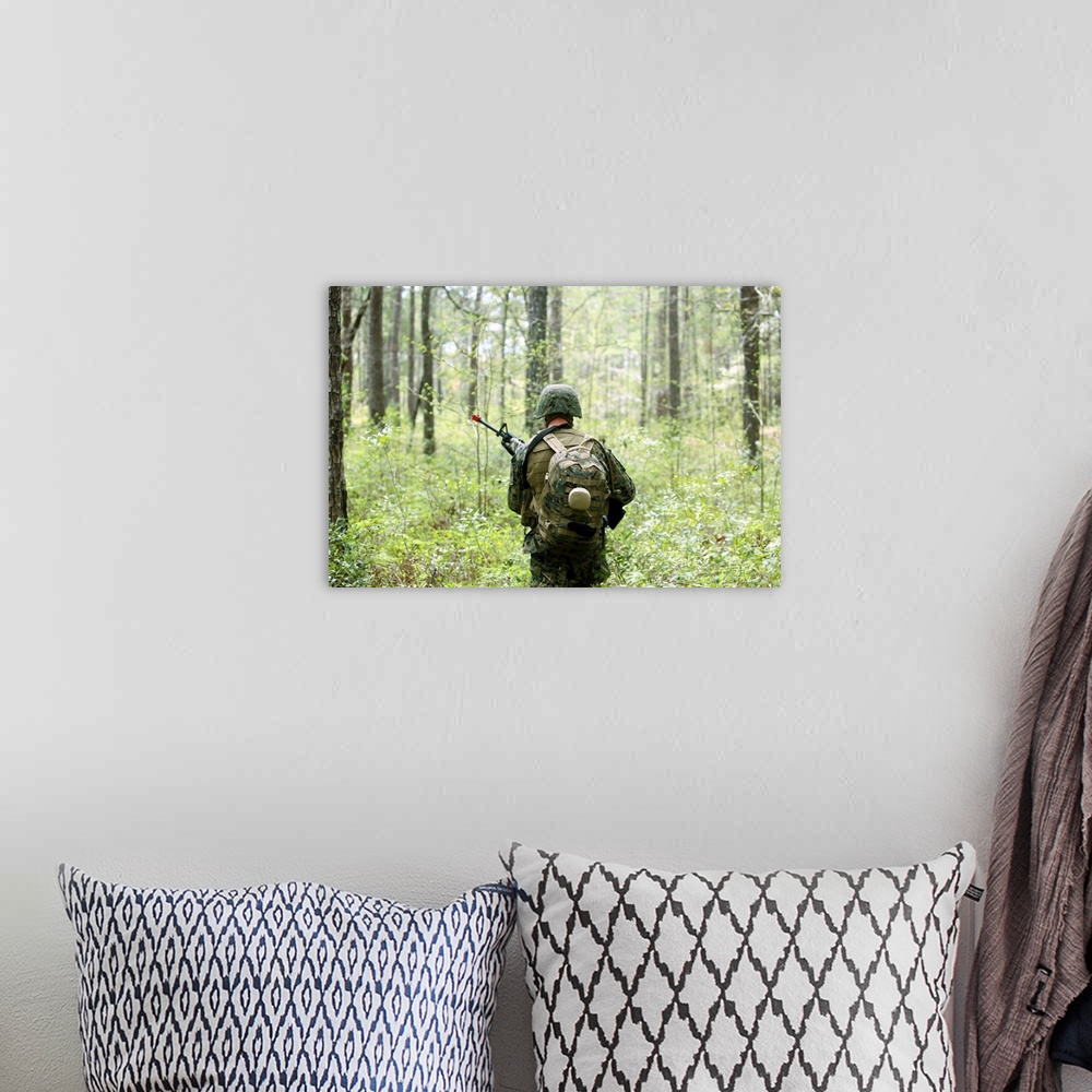 A bohemian room featuring A U.S. Marine patrols through a forest during a field exercise.