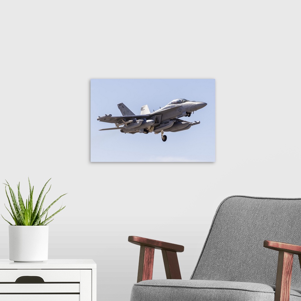 A modern room featuring A U.S. Navy E/A-18G Growler taking off from Nellis Air Force Base, Nevada.