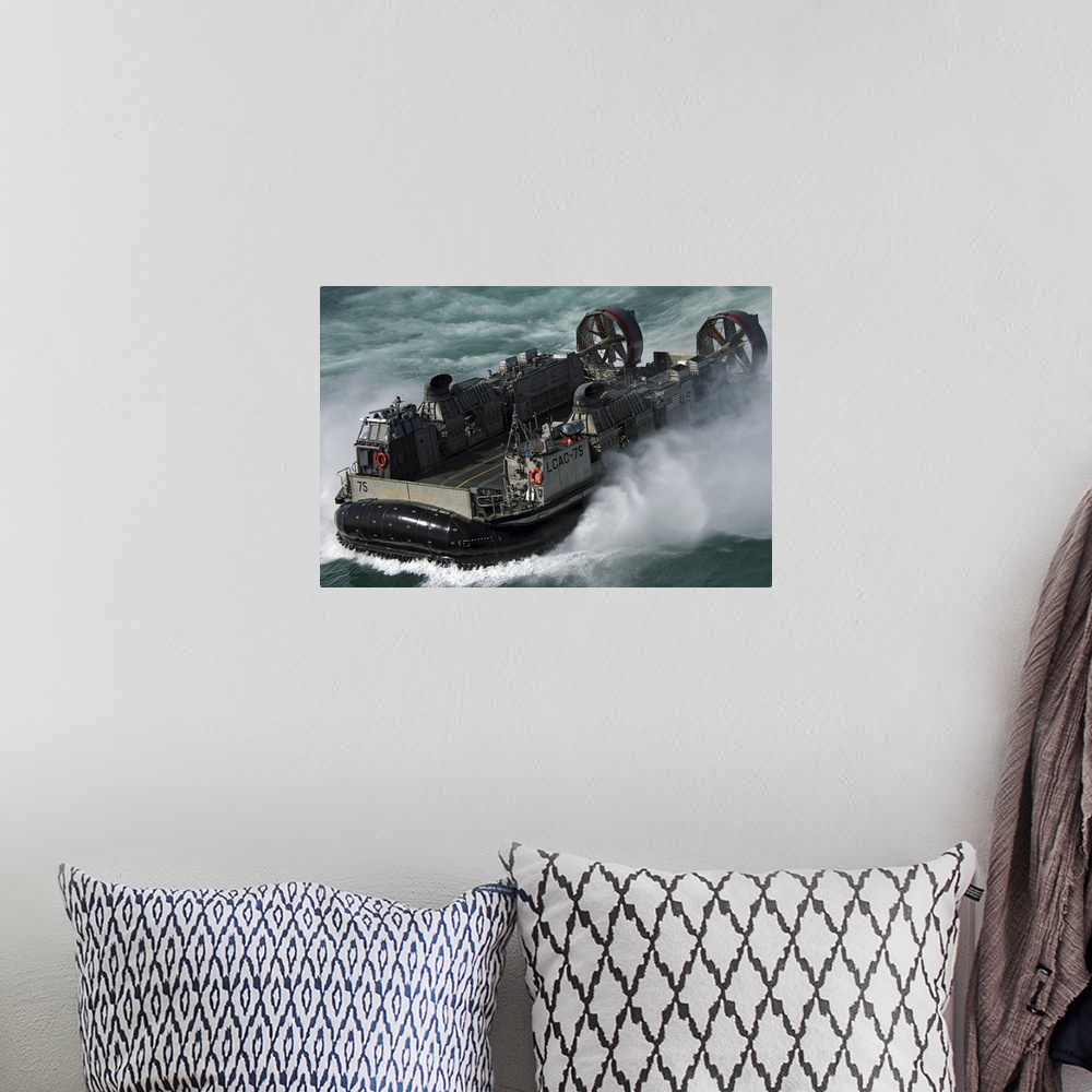 A bohemian room featuring A US Navy Landing Craft Air Cushion heading to the Kuwait Naval Base