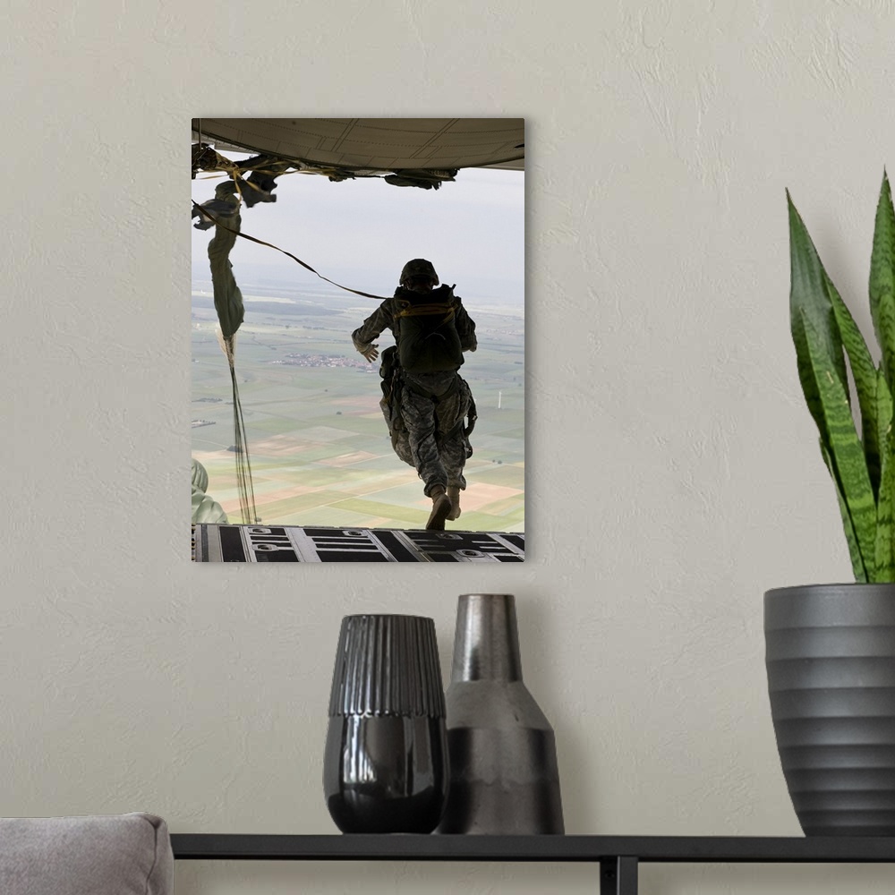 A modern room featuring A U.S. soldier jumps out of a C-130J Super Hercules.