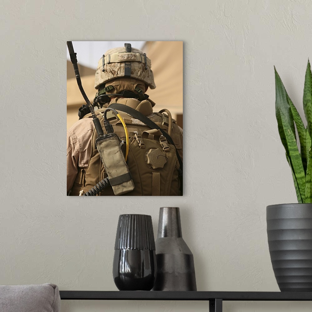 A modern room featuring A vehicle commander with his radio equipment attached to his vest. Each vehicle has a vehicle com...