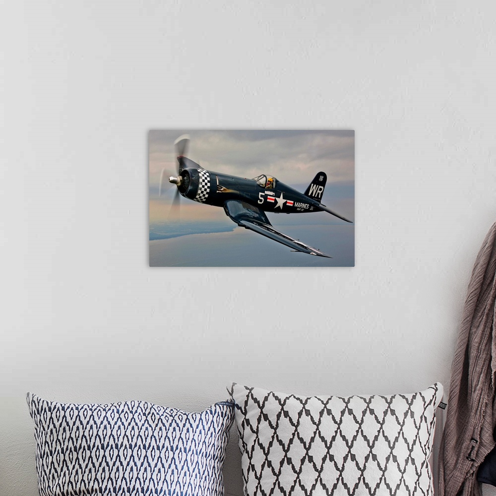 A bohemian room featuring A Vought F4U-5 Corsair in VMF-312 markings during the Korean War, flying over Oshkosh, Wisconsin.