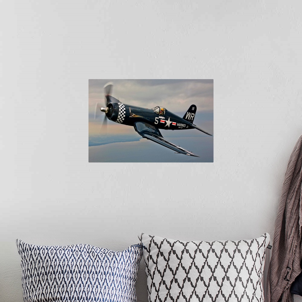 A bohemian room featuring A Vought F4U-5 Corsair in VMF-312 markings during the Korean War, flying over Oshkosh, Wisconsin.
