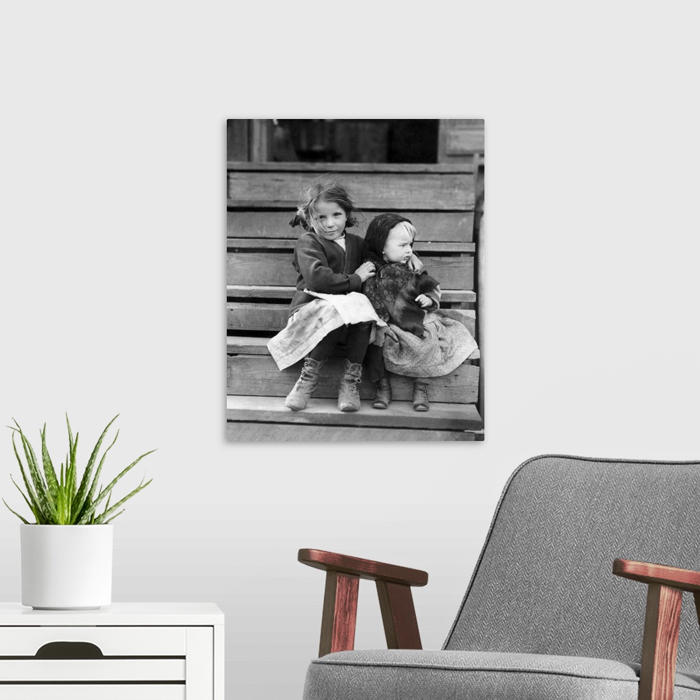 A modern room featuring A young child tending to her younger sister in Bayou La Batre, Alabama.