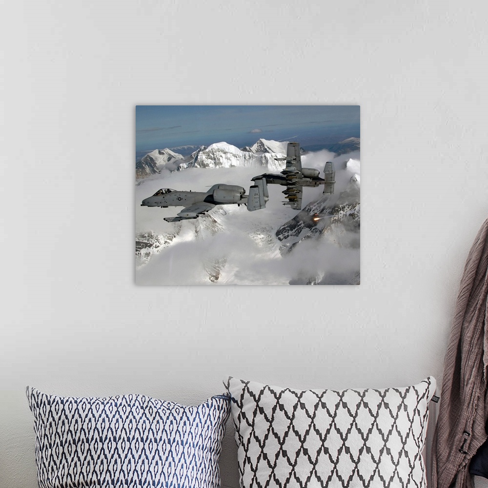 A bohemian room featuring Big, horizontal photograph of two A10 Thunderbolt IIs flying through the clouds, above snow cover...