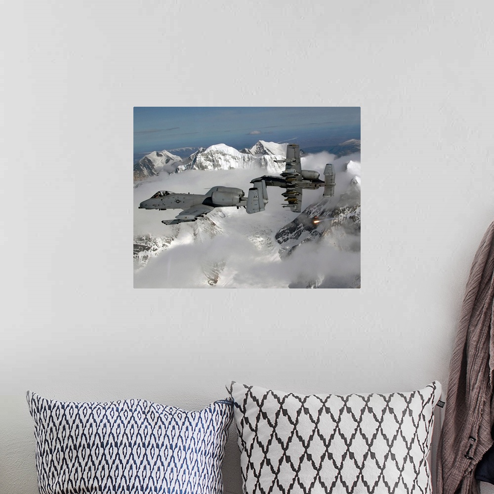 A bohemian room featuring Big, horizontal photograph of two A10 Thunderbolt IIs flying through the clouds, above snow cover...