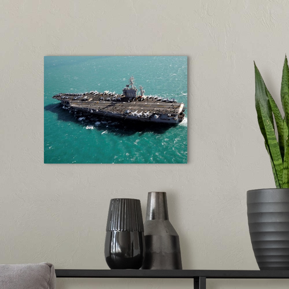 A modern room featuring Aircraft carrier USS Dwight D. Eisenhower sails through the Mediterranean Sea.