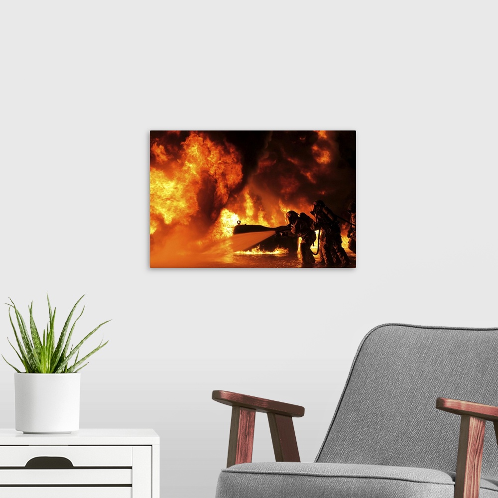 A modern room featuring Aircraft rescue and firefighting Marines extinguish a fuel fire.