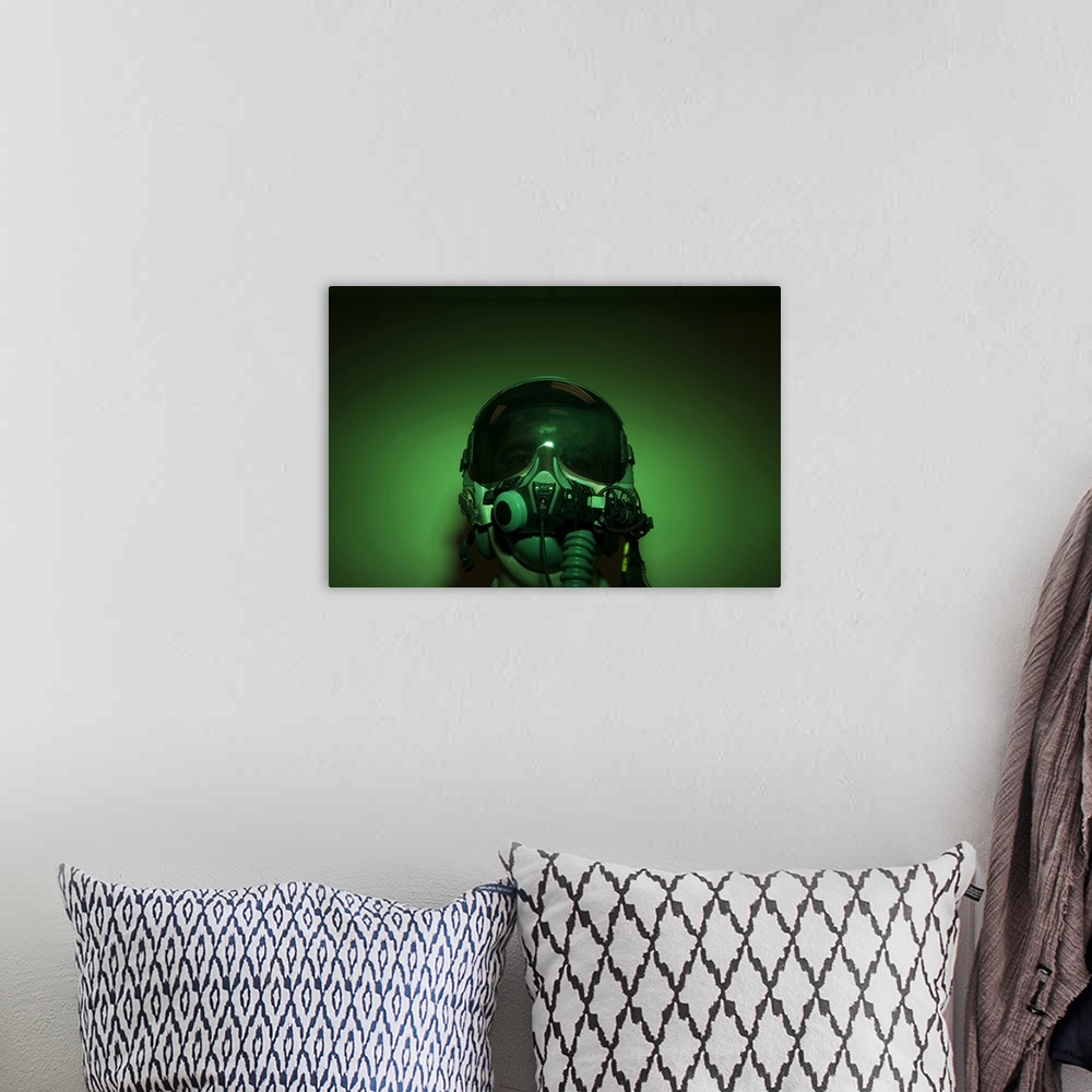 A bohemian room featuring Airman donning flight helmet and night vision goggles.
