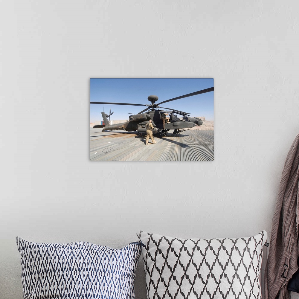 A bohemian room featuring Airmen board an Apache helicopter at Camp Bastion, Afghanistan.