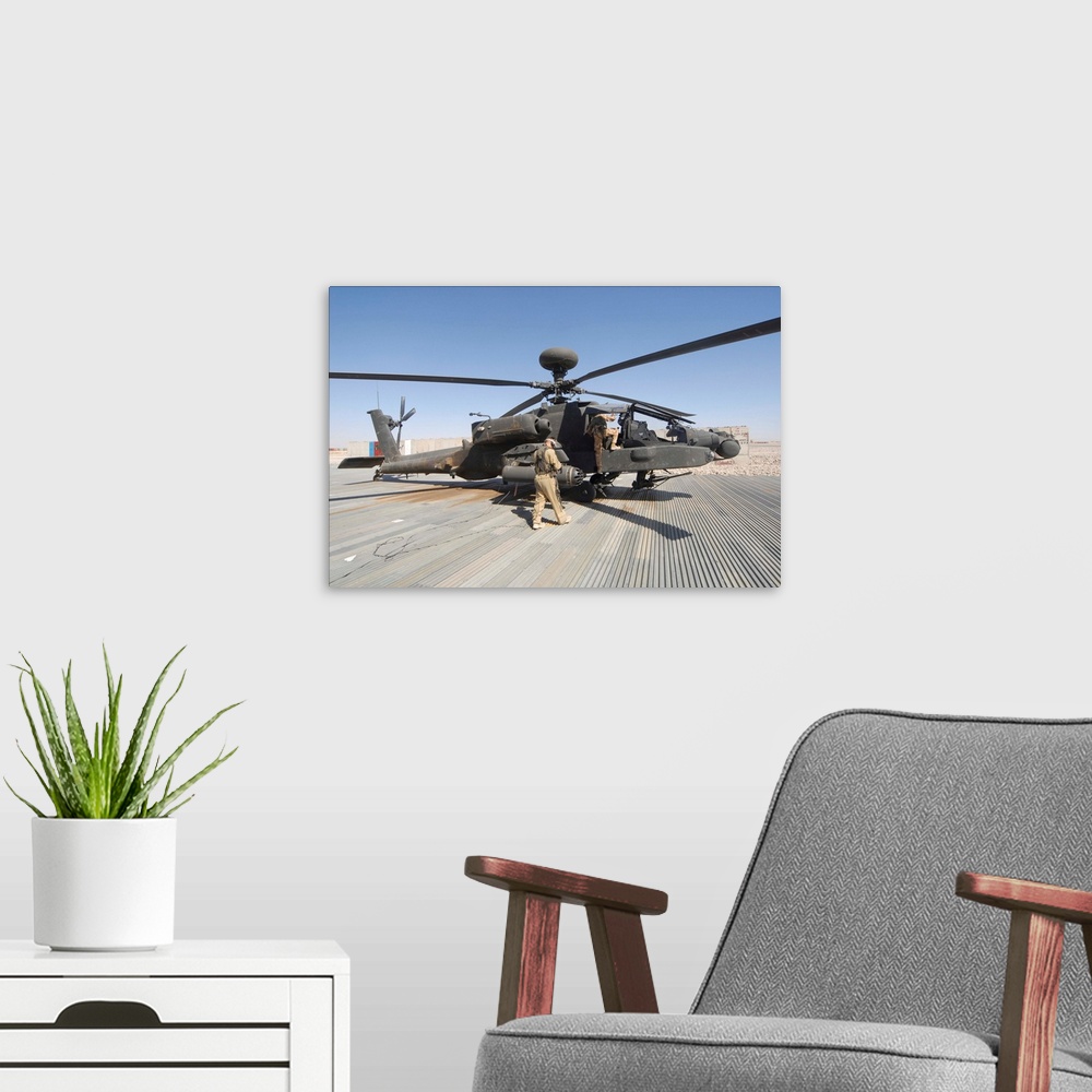 A modern room featuring Airmen board an Apache helicopter at Camp Bastion, Afghanistan.