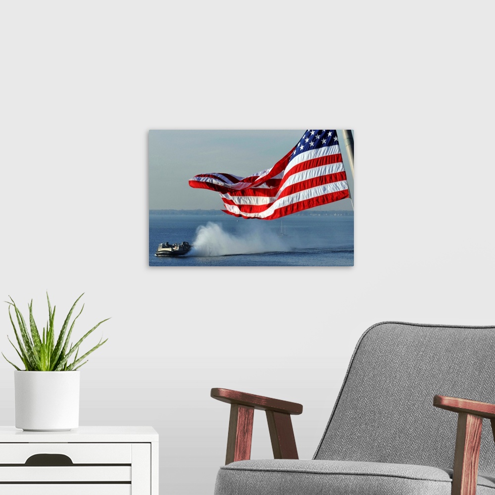 A modern room featuring American flag blowing in the wind with a hovercraft in the background.
