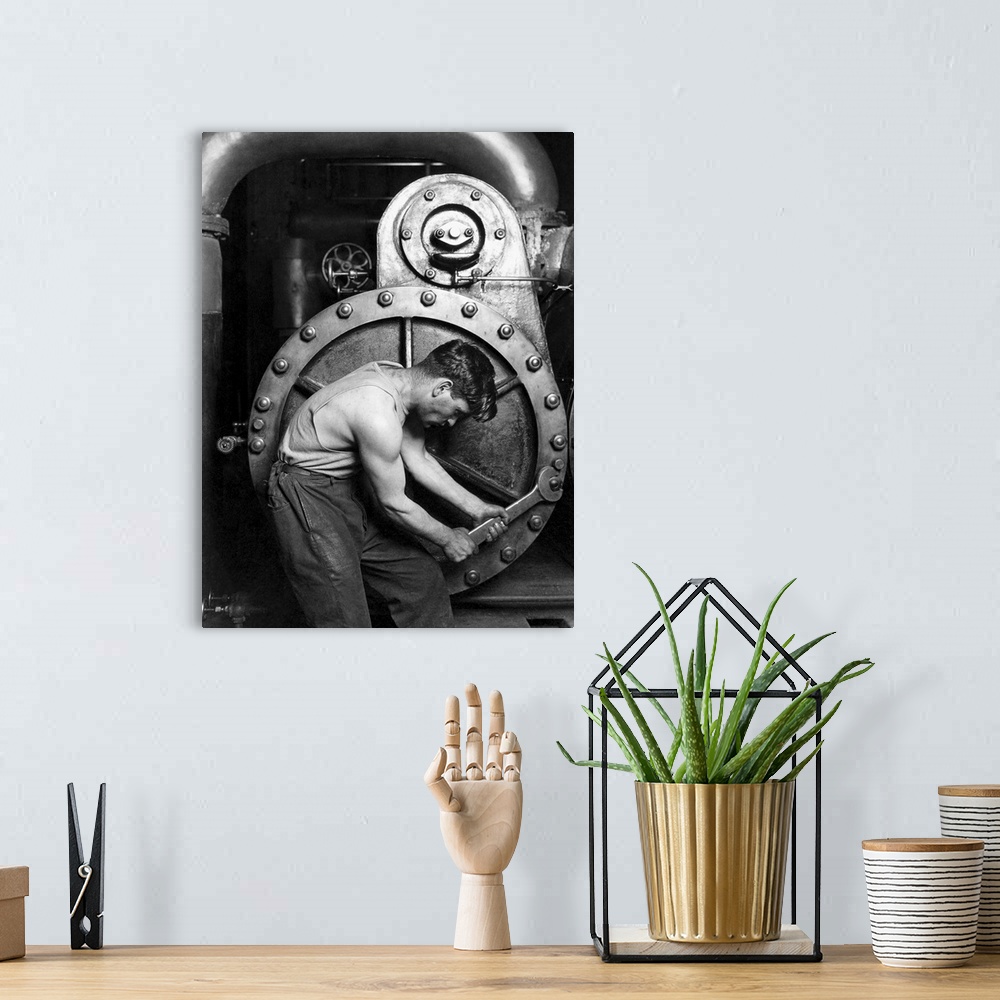 A bohemian room featuring American History photo of a power house mechanic working on a steam pump