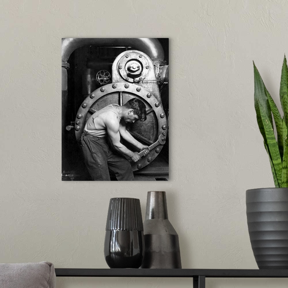 A modern room featuring American History photo of a power house mechanic working on a steam pump