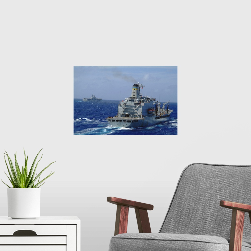 A modern room featuring Amphibious assault ship USS Essex steams near USNS Walter S. Diehl.