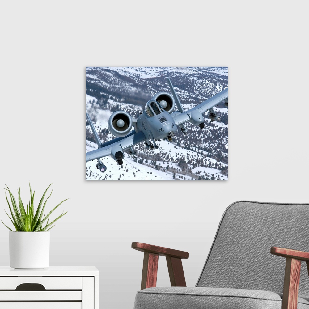 A modern room featuring An A-10C Thunderbolt from the 190th Fighter Squadron flies over the snowy Idaho countryside on a ...