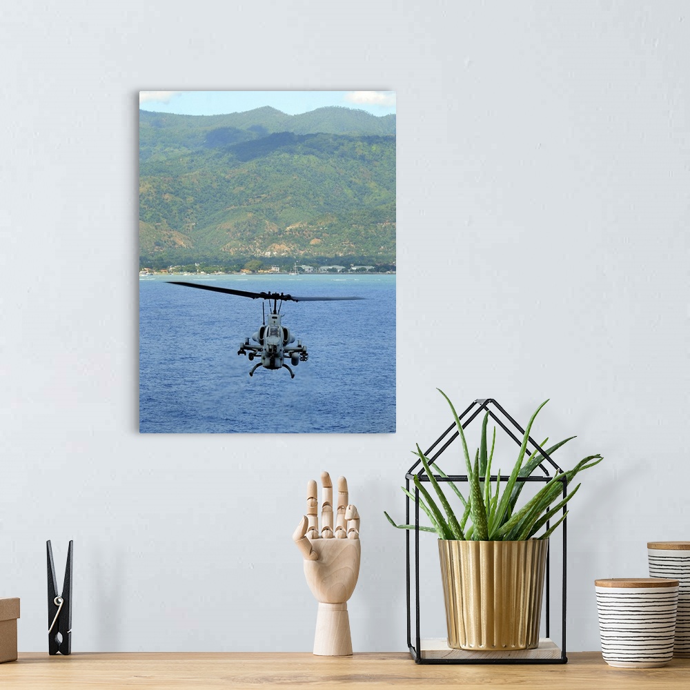 A bohemian room featuring An AH-1W Super Cobra flies off the coast of Dili, East Timor.