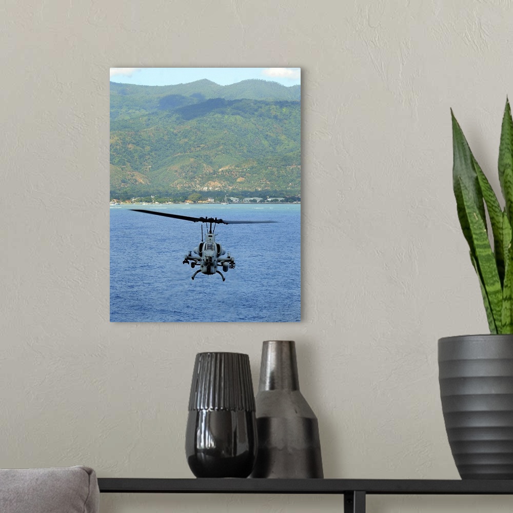 A modern room featuring An AH-1W Super Cobra flies off the coast of Dili, East Timor.