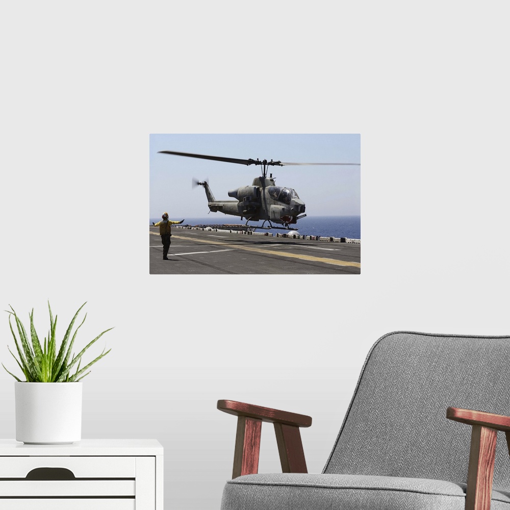 A modern room featuring Red Sea, July 23, 2013 - An AH-1W Super Cobra helicopter takes off from the flight deck of the am...