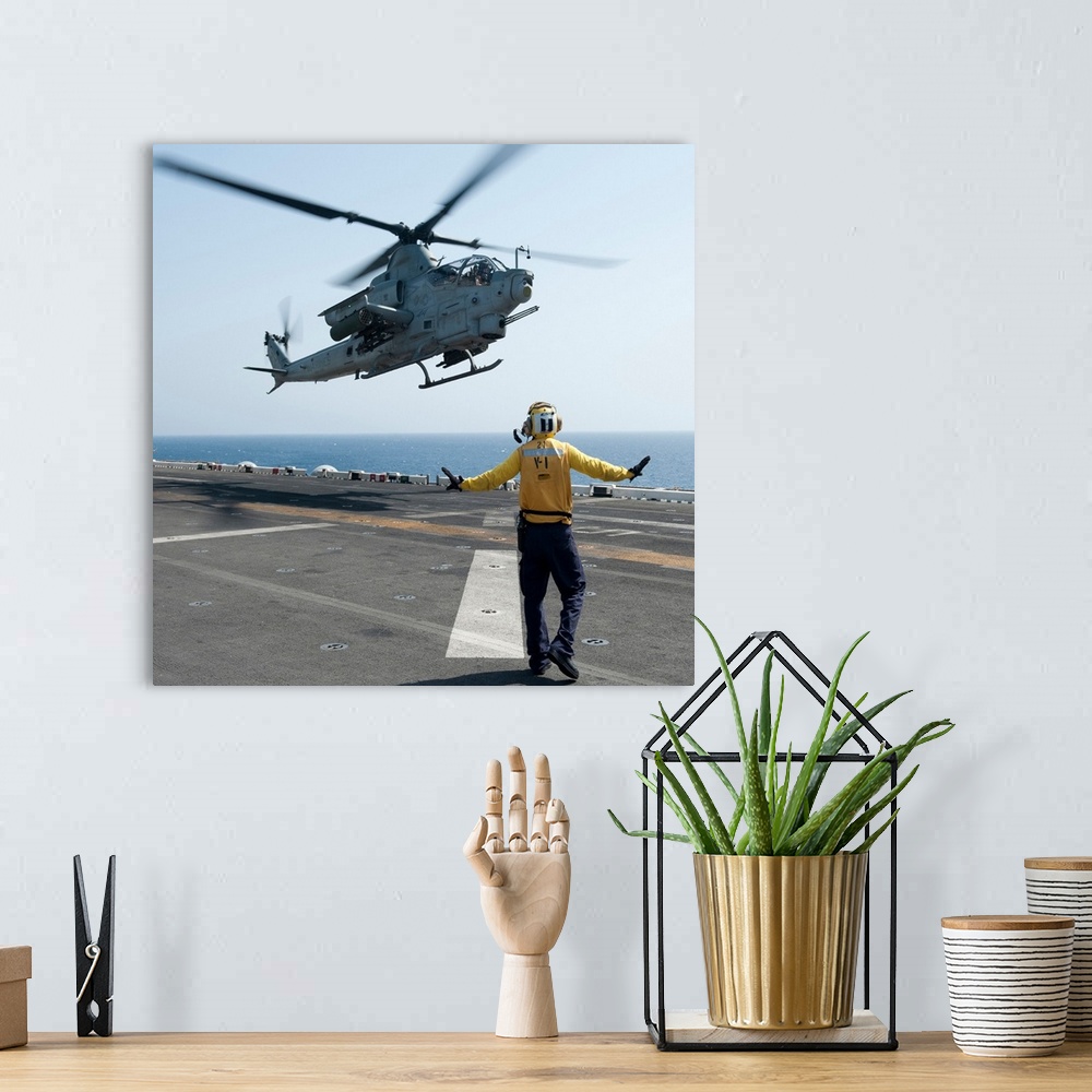 A bohemian room featuring An AH-1Z Cobra helicopter takes off from the flight deck of USS Makin Island.