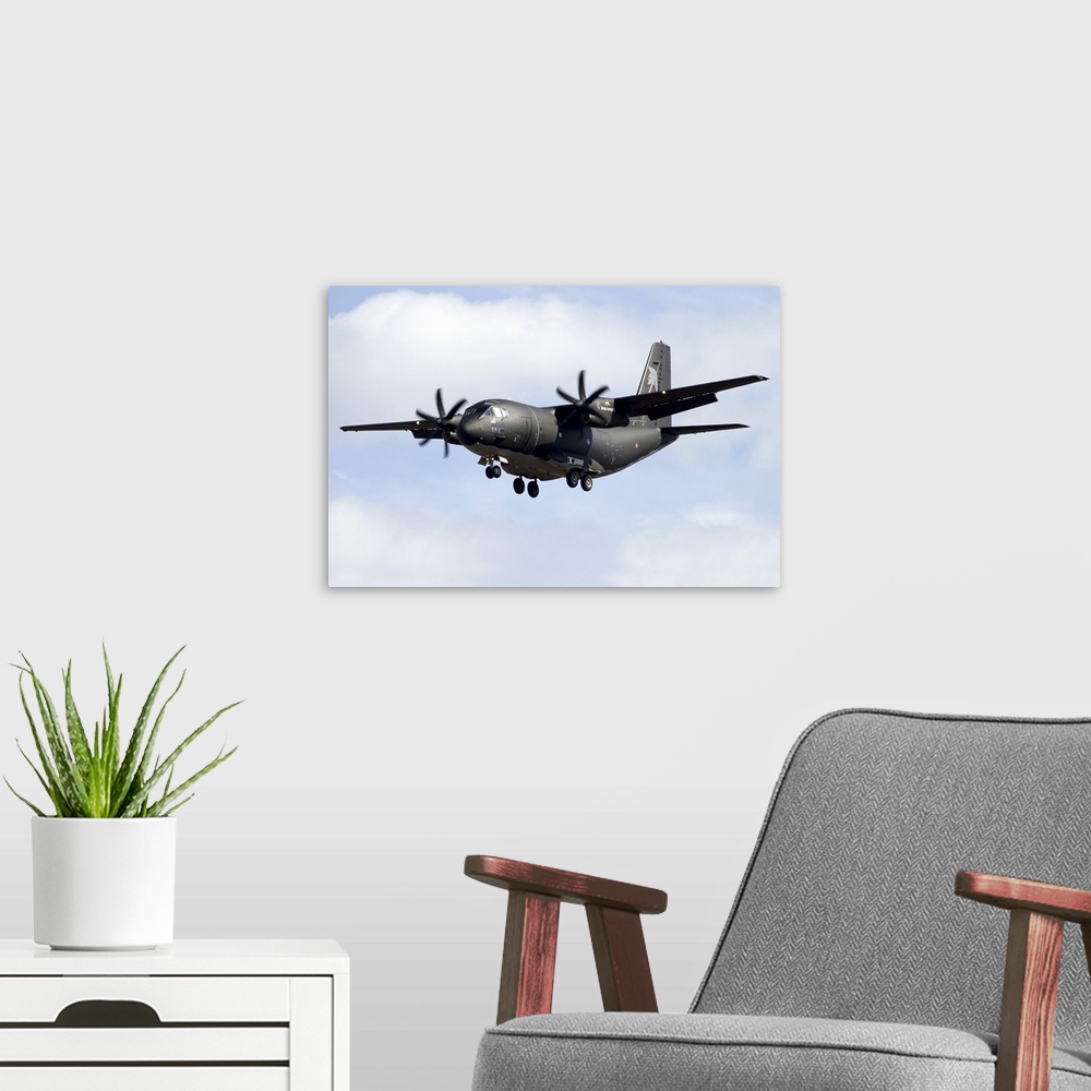 A modern room featuring An Alenia C-27J Spartan of the Italian Air Force in flight over Italy.