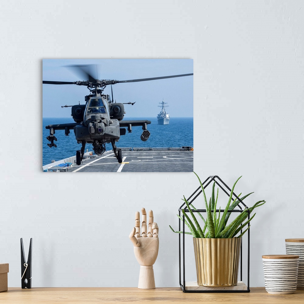 A bohemian room featuring An Army AH-64D Apache helicopter takes off from USS Ponce.