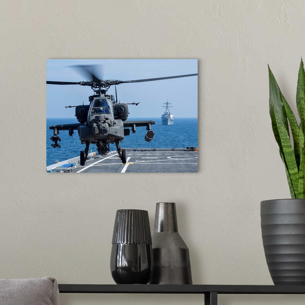 A modern room featuring An Army AH-64D Apache helicopter takes off from USS Ponce.