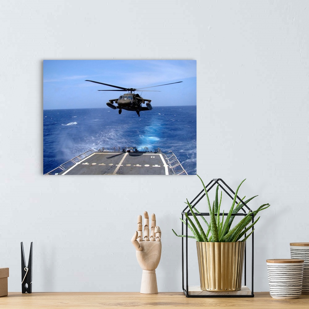 A bohemian room featuring An Army UH-60 Black Hawk helicopter landing aboard the USS Underwood off the coast of Honduras.