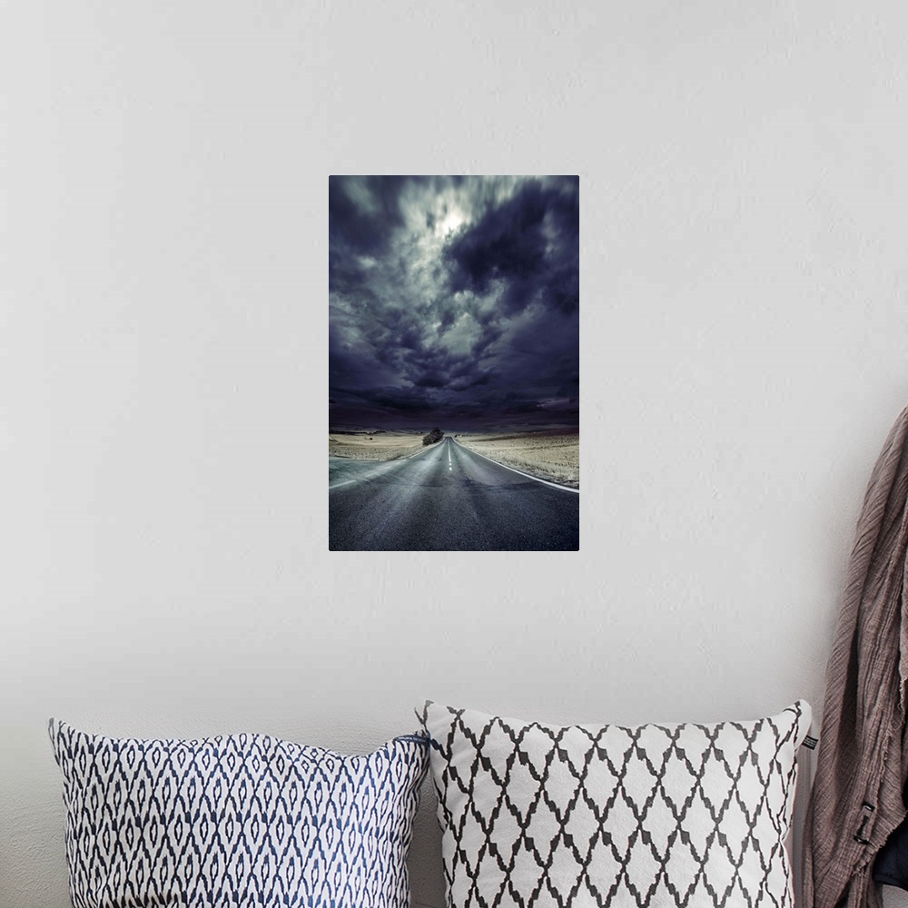 A bohemian room featuring An asphalt road with stormy sky above, Tuscany, Italy.
