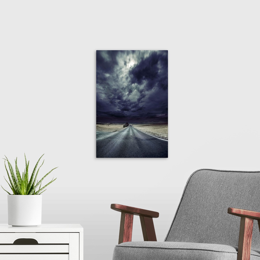 A modern room featuring An asphalt road with stormy sky above, Tuscany, Italy.