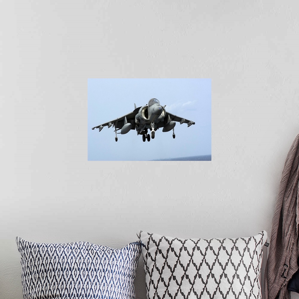 A bohemian room featuring An AV-8B Harrier II  prepares for landing.