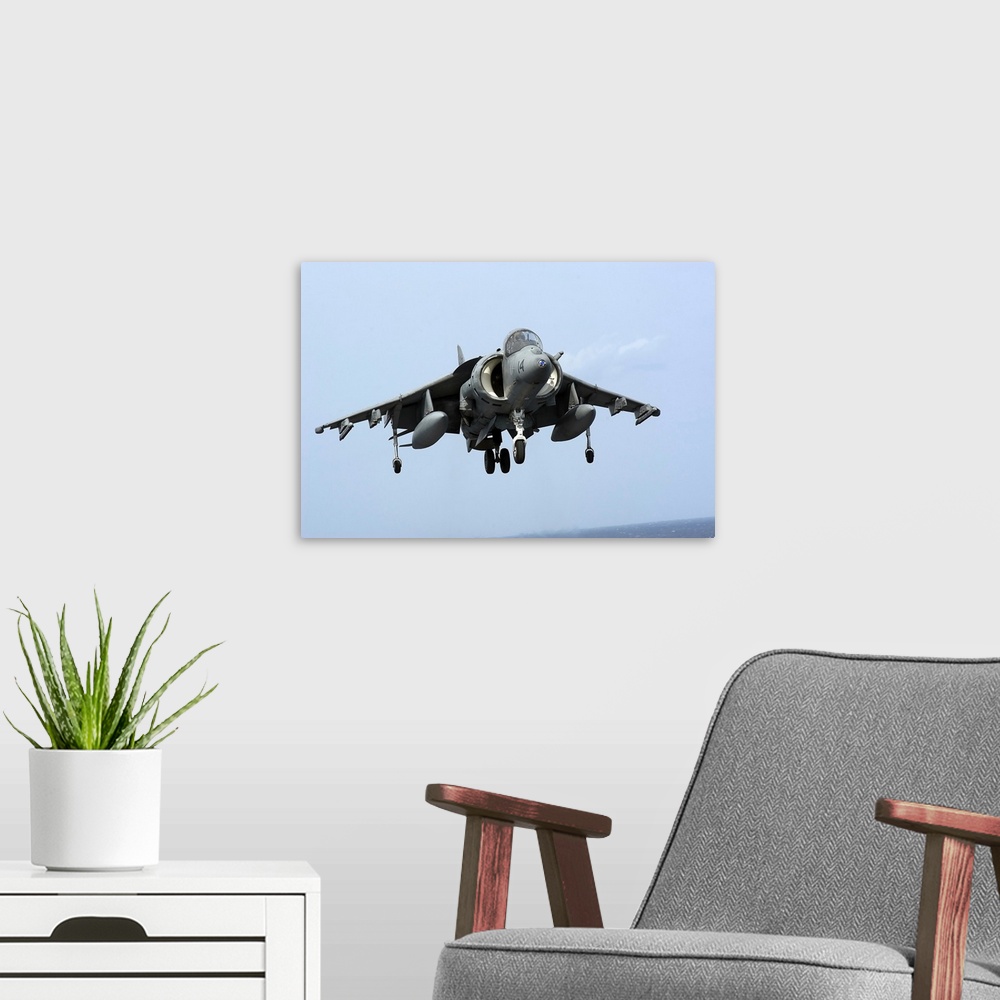 A modern room featuring An AV-8B Harrier II  prepares for landing.