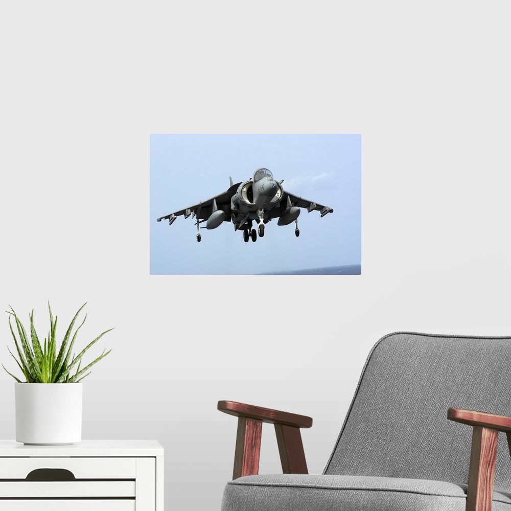 A modern room featuring An AV-8B Harrier II  prepares for landing.