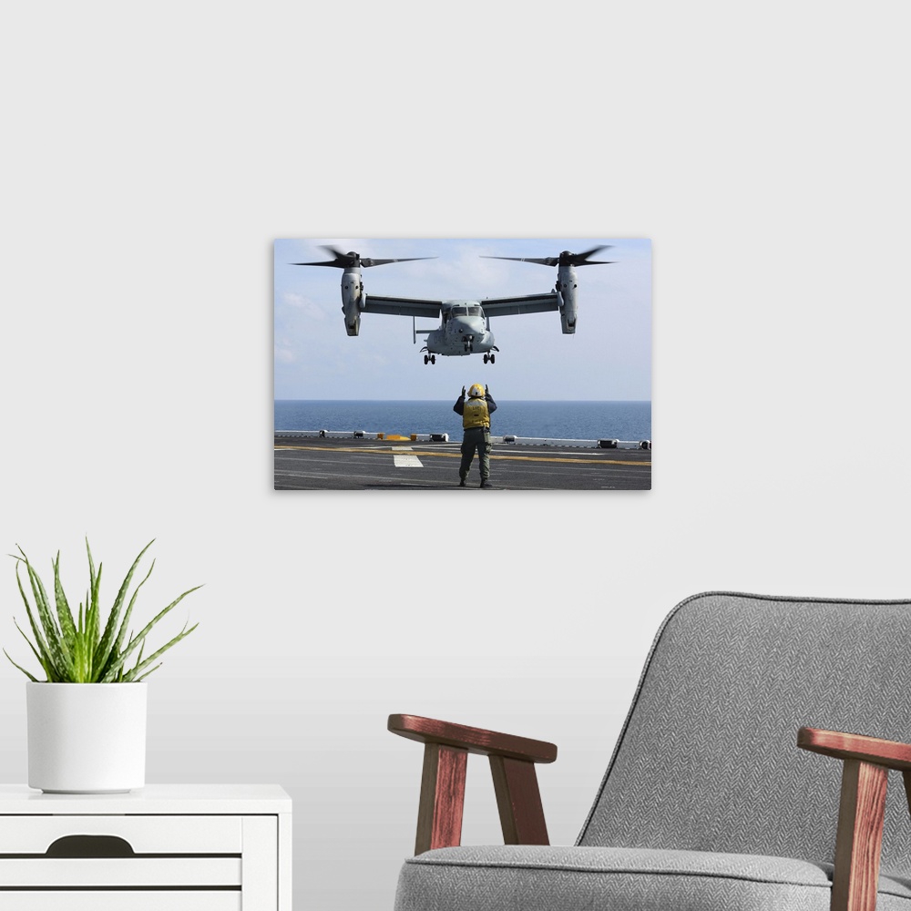 A modern room featuring Atlantic Ocean, February 16, 2013 - An aviation boatswain's mate directs the landing of an MV-22 ...