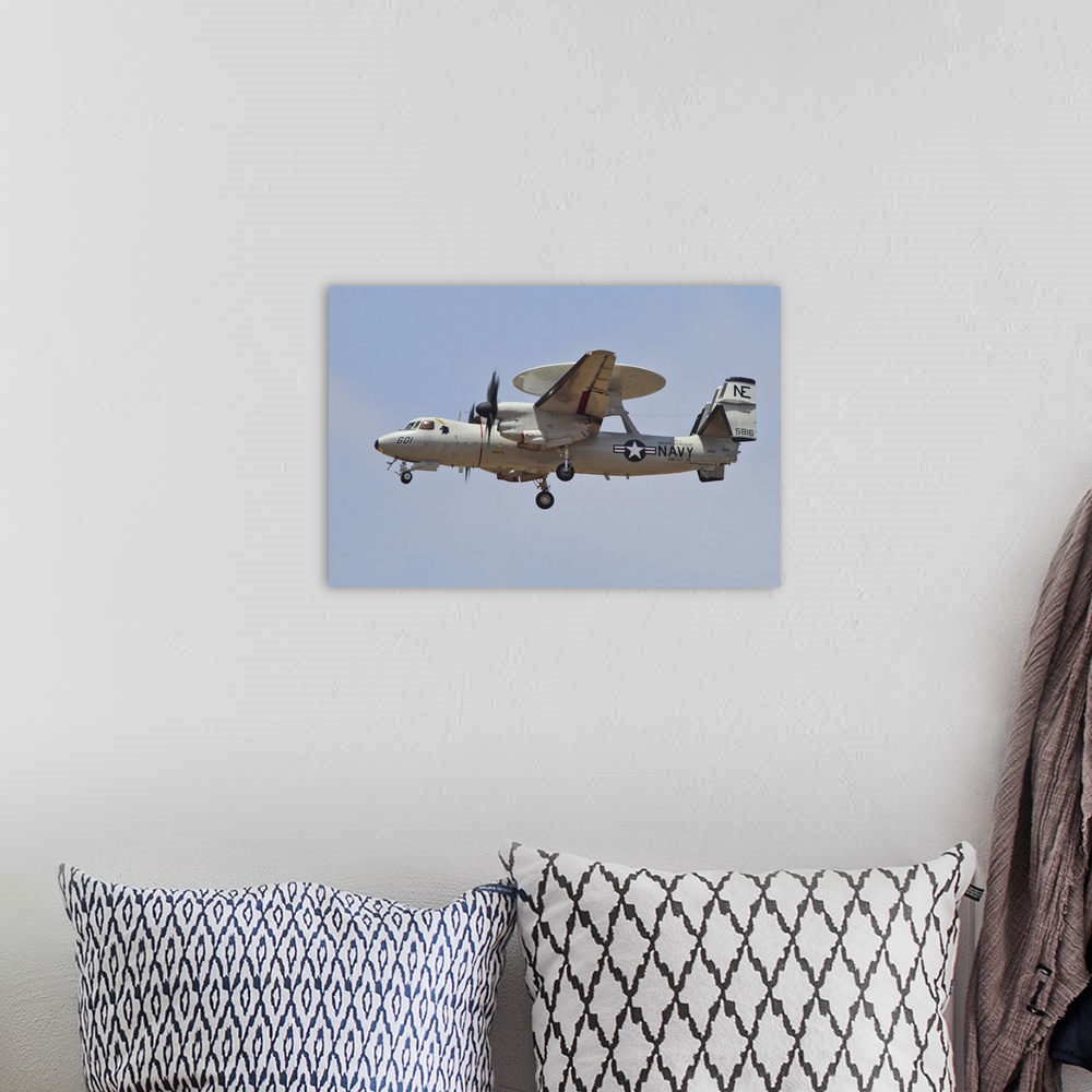 A bohemian room featuring An E-2D Advanced Hawkeye of the U.S. Navy in flight over the Pacific coast of California.