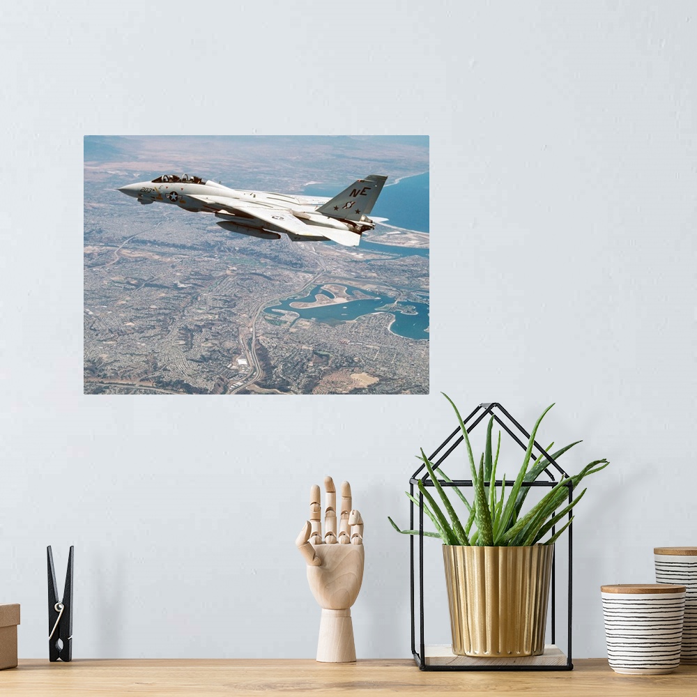 A bohemian room featuring An F-14A Tomcat of U.S. Navy Fighter Squadron 2 (VF-2, the Bounty Hunters) cruises above San Dieg...
