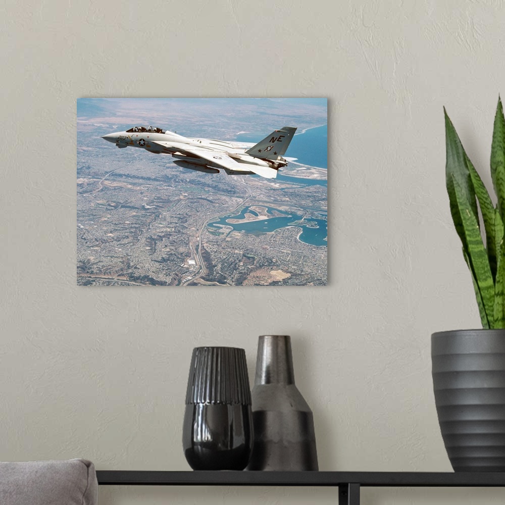 A modern room featuring An F-14A Tomcat of U.S. Navy Fighter Squadron 2 (VF-2, the Bounty Hunters) cruises above San Dieg...