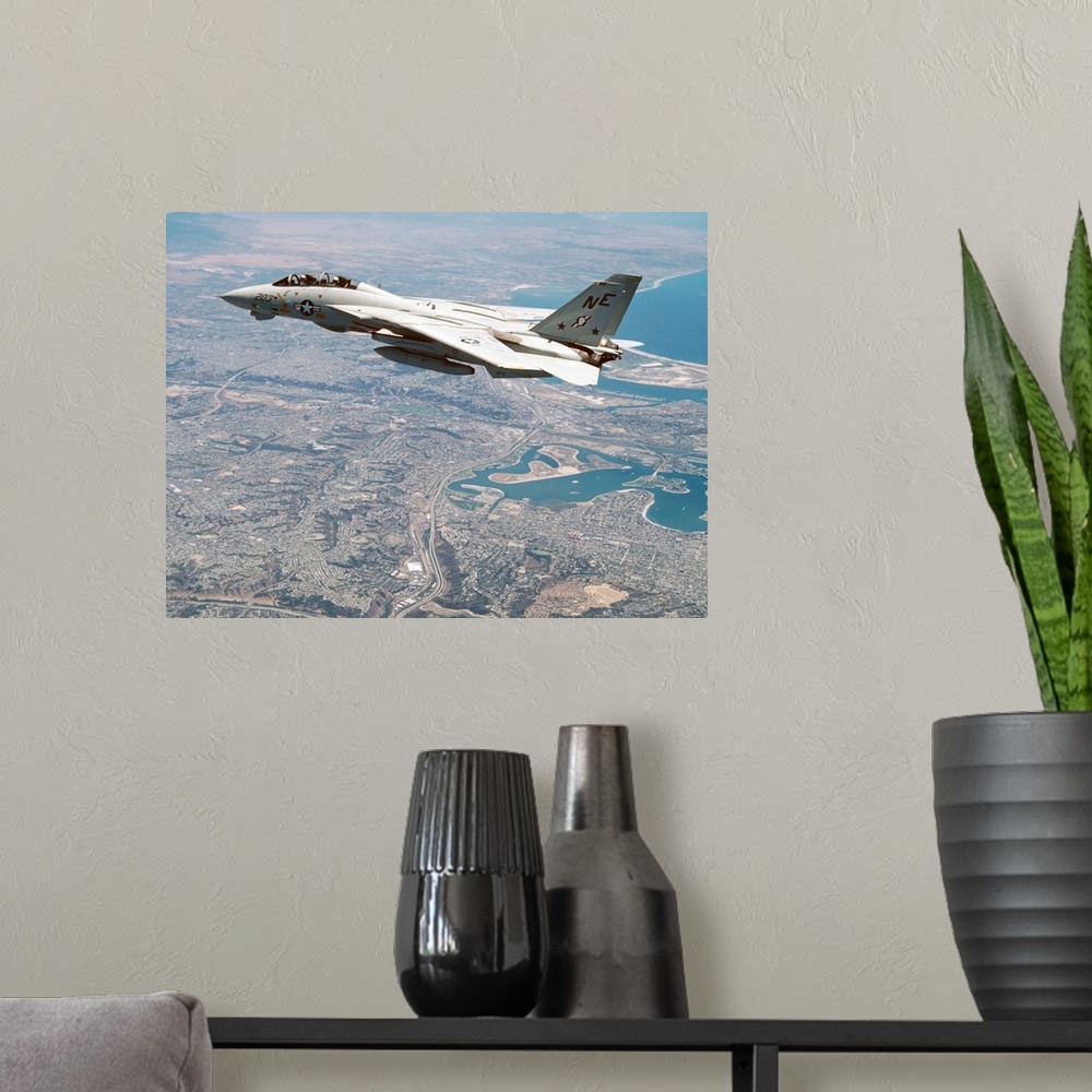 A modern room featuring An F-14A Tomcat of U.S. Navy Fighter Squadron 2 (VF-2, the Bounty Hunters) cruises above San Dieg...