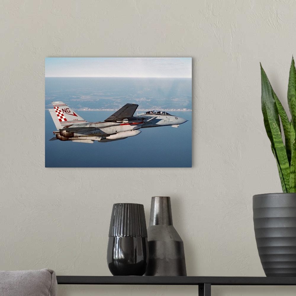A modern room featuring An F-14A Tomcat of U.S. Navy Fighter Squadron 211 (VF-211, the Fighting Checkmates) cruises near ...