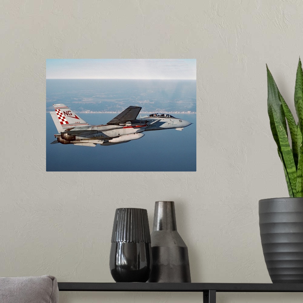 A modern room featuring An F-14A Tomcat of U.S. Navy Fighter Squadron 211 (VF-211, the Fighting Checkmates) cruises near ...