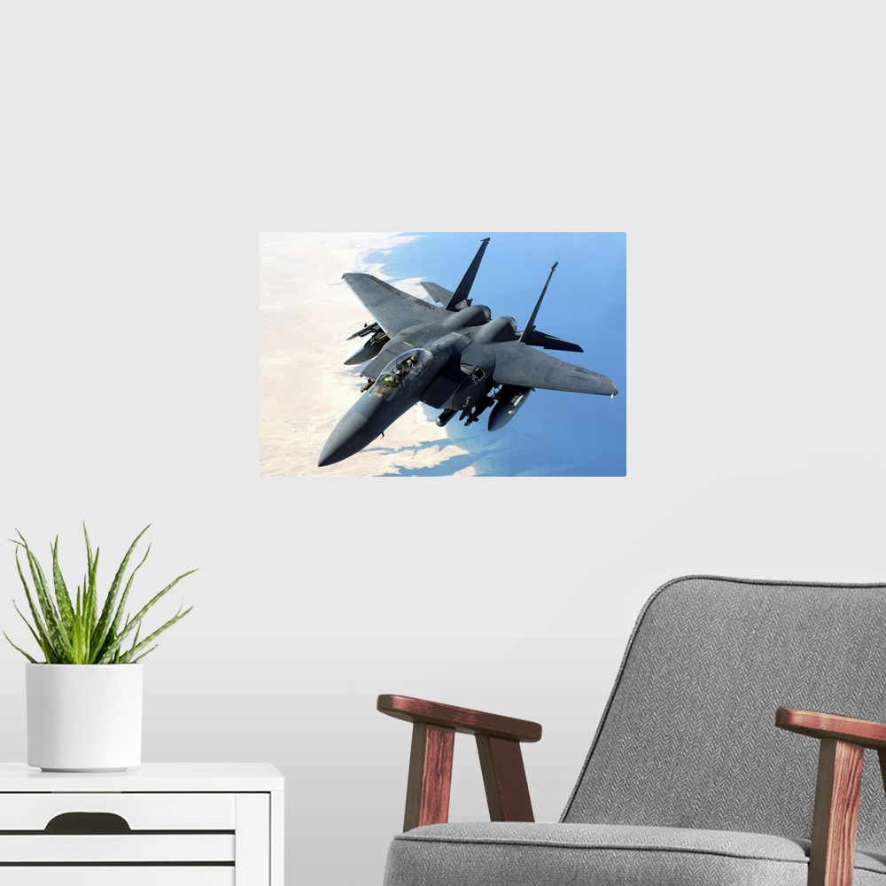 A modern room featuring An F-15E Strike Eagle flies over Iraq during a combat mission.